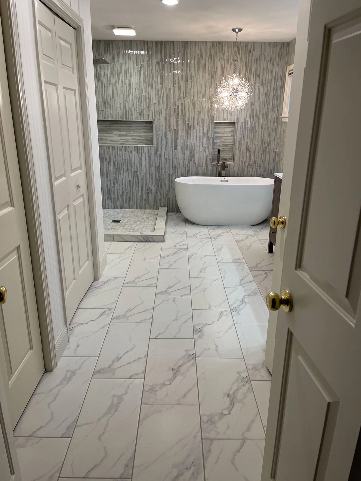 Modern bathroom with freestanding tub and stylish wallpaper